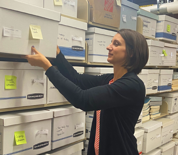An archivist removing a box from a shelf